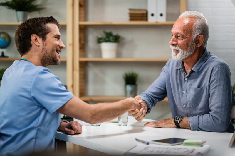 happy-doctor-greeting-handshaking-with-senior-patient-his-office-focus-is-senior-man health-insurance-assurnace-medical-risk-safety-concept